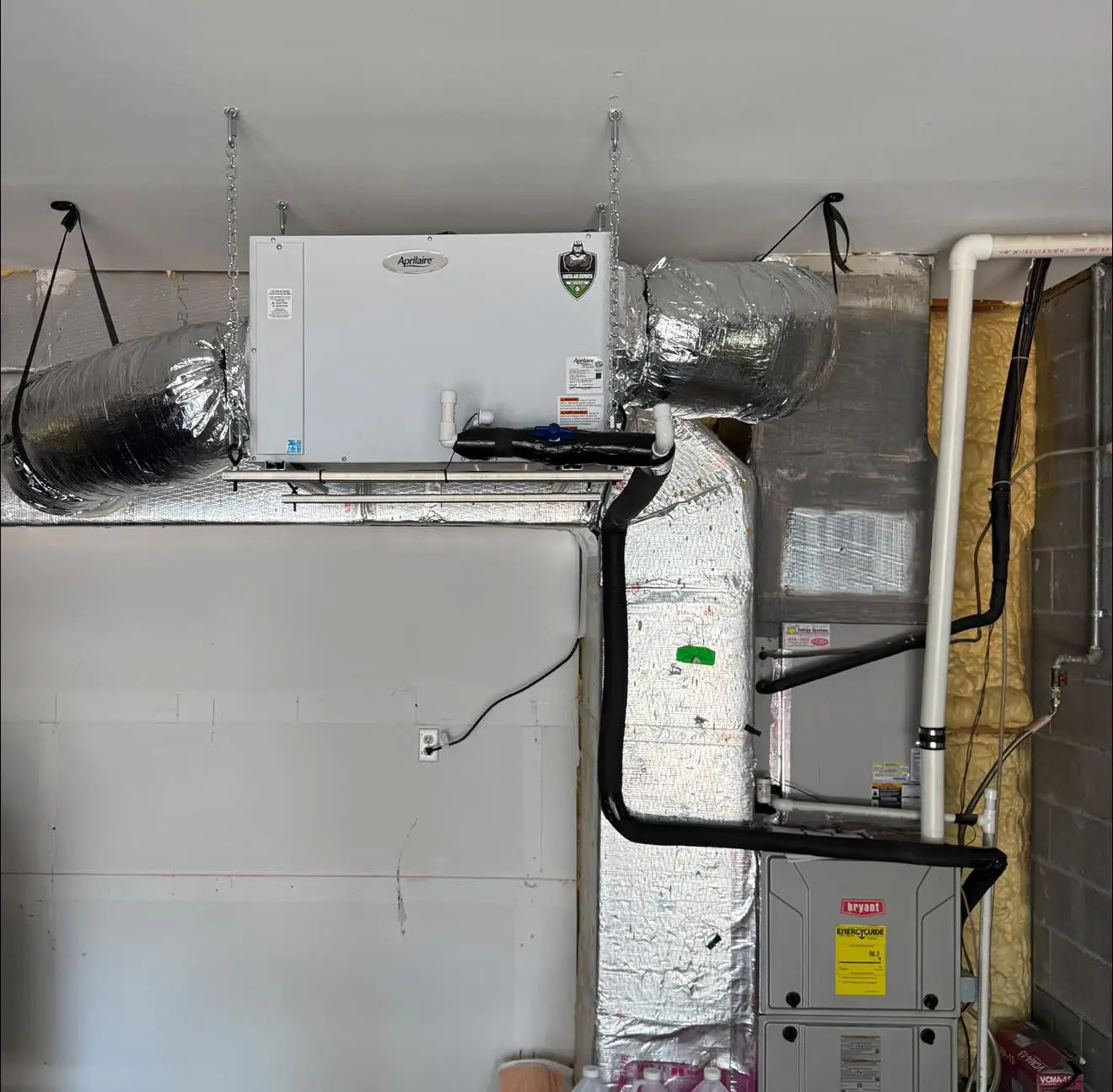 Aprilaire air exchanger and Bryant furnace with insulated ductwork installed on a garage ceiling